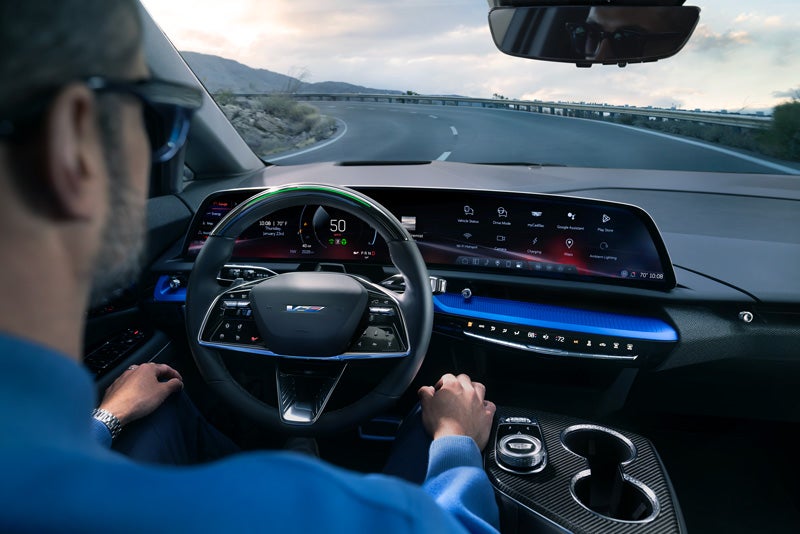 Front View of the 2026 OPTIQ-V Driving Through the Dusk Utilizing its Headlights | Trapp Cadillac in Houma LA